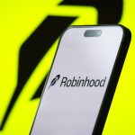 CHONGQING, CHINA - APRIL 26: In this photo illustration, the logo of Robinhood Markets, Inc. is displayed on a smartphone screen, with the company's bright green branding visible in the background, on April 26, 2025, in Chongqing, China. Robinhood is an American financial services company known for its commission-free stock and cryptocurrency trading platform, which has attracted a large base of retail investors, particularly younger users. (