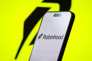 CHONGQING, CHINA - APRIL 26: In this photo illustration, the logo of Robinhood Markets, Inc. is displayed on a smartphone screen, with the company's bright green branding visible in the background, on April 26, 2025, in Chongqing, China. Robinhood is an American financial services company known for its commission-free stock and cryptocurrency trading platform, which has attracted a large base of retail investors, particularly younger users. (