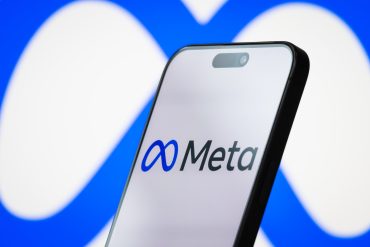 CHONGQING, CHINA - APRIL 26: In this photo illustration, the logo of Meta Platforms, Inc. is displayed on a smartphone screen, with the company's infinity loop-style branding visible in the background, on April 26, 2025, in Chongqing, China. Meta is the parent company of Facebook, Instagram, WhatsApp, and Threads, and is focused on building technologies for social connection, digital advertising, and the development of the metaverse. (