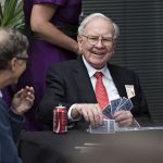 Warren Buffett, chairman of Berkshire Hathaway Inc., center, laughs with Bill Gates, chairman and founder of Microsoft Corp. and a Berkshire Hathaway Inc. director, left, as they play bridge during a shareholder event on the sidelines of the Berkshire Hathaway Inc. annual shareholders meeting in Omaha, Nebraska, U.S., on Sunday, May 3, 2015. More than 40,000 people were expected to attend yesterday's Berkshire Hathaway annual meeting, which marks Warren Buffett's 50th year running the company. Photographer: Daniel Acker/Bloomberg via Getty Images