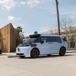 Waymo autonomous vehicle operating in downtown Dallas with skyline in background