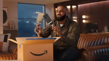 Amazon Prime Day banner showing shopping carts, digital checkout icons, and content creators streaming product reviews during a record-breaking retail event.