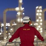 Shell logo at oil refinery under cloudy skies, representing energy sector uncertainty and Q2 production challenges