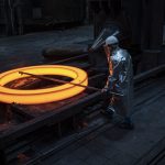 Arbeitssicherheit, Dortmund, OSH, Produktionsanlage, Produktionsmitarbeiter, Ringe, Rohlinge, Schutzkleidung, Silbermantel, blanks, measuring, messen, nahtlos gewalzte Ringe, production plant, production worker, protection gear, rings, rothe erde Ringe, rothe erde rings, seamless rolled rings, silver coat, thyssenkrupp rothe erde, Adult, Architecture, Building, Factory, Hardhat, Helmet, Male, Man, Person, Worker Ein glühender Ring. Der Mitarbeitende vermisst den Ring.
