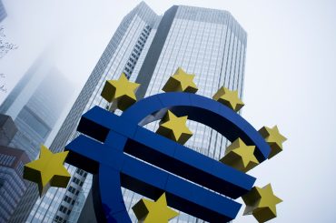 Illustration of the EU headquarters with digital AI compliance graphics, symbolizing the launch of AMLA and AI-powered monitoring across Europe.