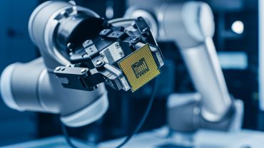 Modern High Tech Authentic Robot Arm Holding Contemporary Super Computer Processor. Industrial Robotic Manipulator End Effector Holding CPU Chip