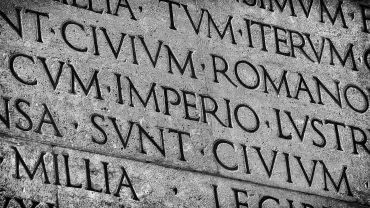 Aeneas AI interface analyzing ancient Roman Latin inscription carved in stone / Latin ancient language and classical education. Inscription from Emperor Augustus famous Res Gestae (1st century AD), with the word Imperio in the center (Black and White)