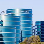 Oracle data center illuminated with AI symbols and charts rising, representing enterprise cloud investment surge amid shifting CIO priorities.