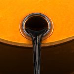 OPEC+ delegates at meeting discussing oil production amid falling Brent crude prices below $70