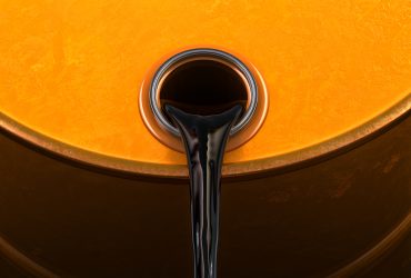 OPEC+ delegates at meeting discussing oil production amid falling Brent crude prices below $70