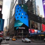 Digital display board showing Nasdaq logo and crypto icons like Bitcoin and Ethereum, symbolizing new listing access for institutional ETPs.