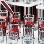 Scientist examining radiopharmaceutical compounds for cancer therapy in high-tech oncology lab