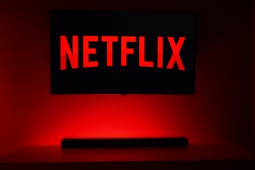 Acclaimed film director on a production set with Netflix branding, symbolizing streaming-driven creative freedom and global audience access