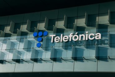 Telefónica headquarters in Spain with digital breach overlay symbolizing cybersecurity incident