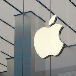 Apple store exterior with customers walking by, reflecting strong iPhone sales in Q3 2025