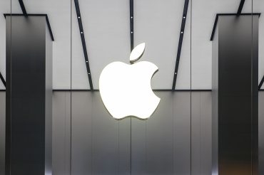 Rare earth magnet on Apple logo, symbolizing U.S. tech independence from China.