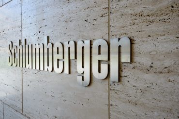 HOUSTON, UNITED STATES - FEBRUARY 2016: Schlumberger - the biggest international oilfield service company sign made of metal plates on wall on February 2016 in Houston, United States.