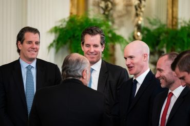 Tyler Winklevoss, co-founder and CEO of Gemini Trust Co (L), Cameron Winklevoss, co-founder and president of Gemini Trust Co., Brian Armstrong, CEO of Coinbase Global Inc., and Paolo Ardoino, CEO of Tether Holdings Ltd., with Howard Lutnick, US commerce secretary, during a signing ceremony for the GENIUS Act in the East Room of the White House in Washington, DC, US, on Friday, July 18, 2025 / Photographer: Al Drago / Bloomberg via Getty Images