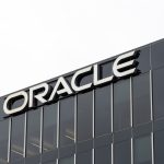 Rows of Oracle-badged GPU servers in a high-density AI cluster. Austin, Texas, USA - March 17, 2022: Closeup of Oracle sign on the building at its headquarters in Austin, Texas, USA. Oracle Corporation is an American multinational computer technology corporation.