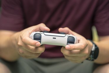 Person playing Sony PlayStation Console