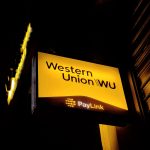 Western Union signage displayed outside a retail money transfer location, symbolizing its $500M Intermex acquisition to expand Hispanic remittance services