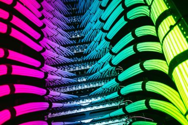 Rows of AI servers with liquid-cooled GPU trays in a new data center.