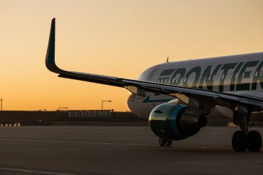 Frontier Airlines planes taxi at Denver International Airport in Denver, Colorado