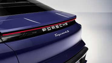 Luxury Porsche SUV in production line, symbolizing shift back to combustion and hybrid models