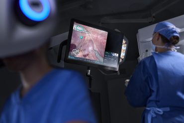 Healthcare workers using predictive analytics dashboards to manage patient data and treatment plans.