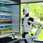 Galbot humanoid robot salesperson delivers a drink for a customer at the 9-square-meter bus shop in ART PARK on August 10, 2025 in Beijing, China. Galbot, the developer of the robot, plans to establish 100 stores across 10 cities in China this year, with expectations of serving up to 2,000 customers per store every day. (Photo by Song Jiaru/VCG via Getty Images)