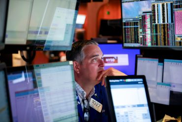 A trader works on the floor at the New York Stock Exchange (NYSE) in New York,