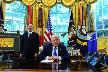US President Donald Trump and Howard Lutnick, US commerce secretary, left, in the Oval Office of the White House in Washington, DC, US, on Friday, Sept. 19, 2025. Trump is signing a proclamation that would move to extensively overhaul the H-1B visa program, requiring a $100,000 fee for applications in a bid to curb overuse, according to a White House official familiar with the matter. Photographer: Aaron Schwartz/CNP/Bloomberg via Getty Images