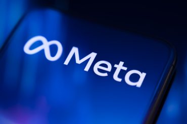 Meta logo on the smartphone Visual representation of Meta platforms offering paid ad-free subscription alternative alongside free ad-supported access.