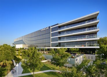 Oracle HQ building with logo — Oracle surges after unveiling record $455B AI cloud backlog.