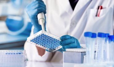 Biotech researcher analyzing genetic therapy samples in lab