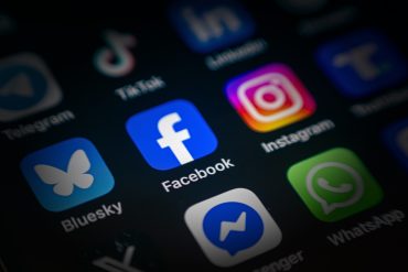 Facebook mobile screen. User browsing Facebook on smartphone in the UK with option to upgrade to ad-free subscription.