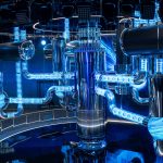 A water-water nuclear reactor model on display in a contemporary exhibition venue, illuminated by striking blue lights and featuring sleek metallic components.