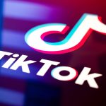 TikTok logo reflecting on a US flag