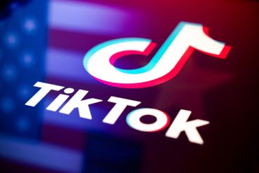 TikTok logo reflecting on a US flag