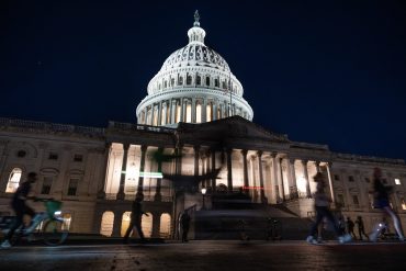 Dimly lit U.S. Capitol surrounded by circuit-like lines, symbolizing a frozen government halting the nation’s tech operations.