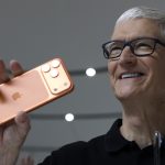Apple CEO Tim Cook holds up a new iPhone 17 Pro during an Apple special event at Apple headquarters