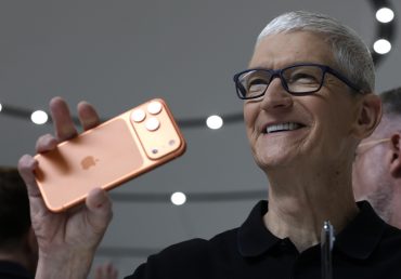 Apple CEO Tim Cook holds up a new iPhone 17 Pro during an Apple special event at Apple headquarters