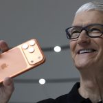Apple CEO Tim Cook holds up a new iPhone 17 Pro during an Apple special event at Apple headquarters
