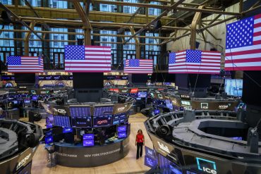 Traders work on the floor of the New York Stock Exchange (NYSE)