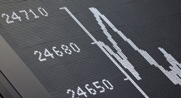 A display showing the German Stock Market Index DAX is pictured at the stock exchange in Frankfurt, western Germany, on October 9, 2025. Frankfurt's DAX index of blue-chip German companies opened at a record high on October 9, 2025 as investors shrugged off political and fiscal uncertainty in the United States and Europe.