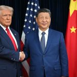 US President Donald Trump (L) and China's President Xi Jinping shake hands as they arrive for talks at the Gimhae Air Base, located next to the Gimhae International Airport in Busan on October 30, 2025