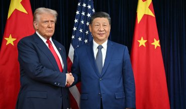 US President Donald Trump (L) and China's President Xi Jinping shake hands as they arrive for talks at the Gimhae Air Base, located next to the Gimhae International Airport in Busan on October 30, 2025