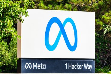 Meta headquarters in Menlo Park illuminated at dusk during earnings week, symbolizing the balance between advertising power and heavy AI investment.