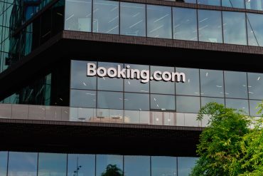 Exterior of Booking.com headquarters in Amsterdam, Netherlands. Booking Holdings posts $9B in Q3 as Connected Trip bundling, disciplined marketing, and platform scale drive durable growth.