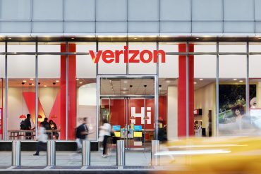 Verizon retail outlet in New York City with branded signage and customers entering the store.